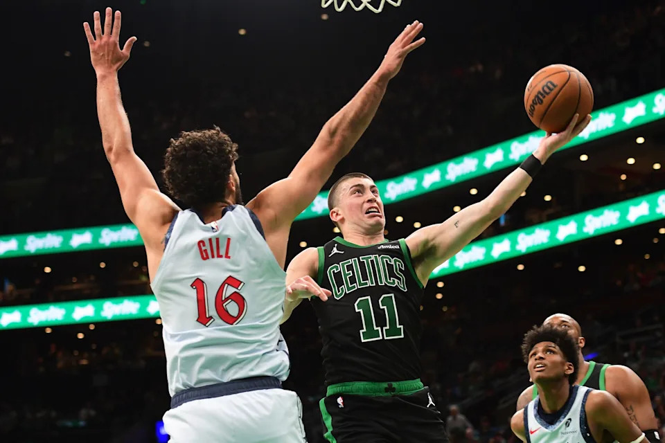 Apr 6, 2025; Boston, Massachusetts, USA; Boston Celtics guard Payton Pritchard (11) drives to the basket while Washington Wizards forward Anthony Gill (16) defends during the second half at TD Garden. Mandatory Credit: Bob DeChiara-Imagn Images