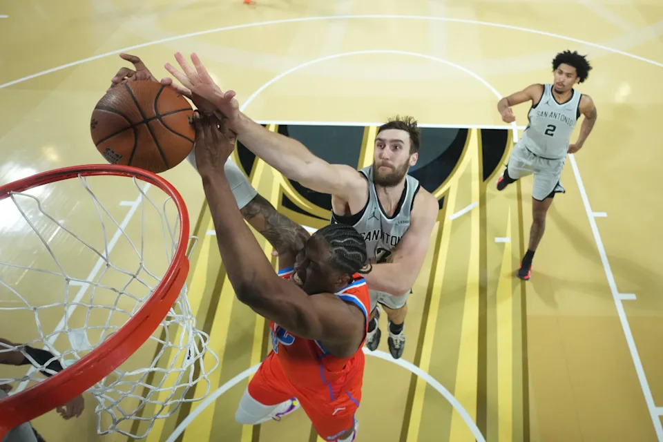 Dec 13, 2025; Las Vegas, Nevada, USA; Oklahoma City Thunder guard Jalen Williams (8) and San Antonio Spurs center Luke Kornet (7) battle for the rebound during the second half at T-Mobile Arena. Mandatory Credit: Kirby Lee-Imagn Images