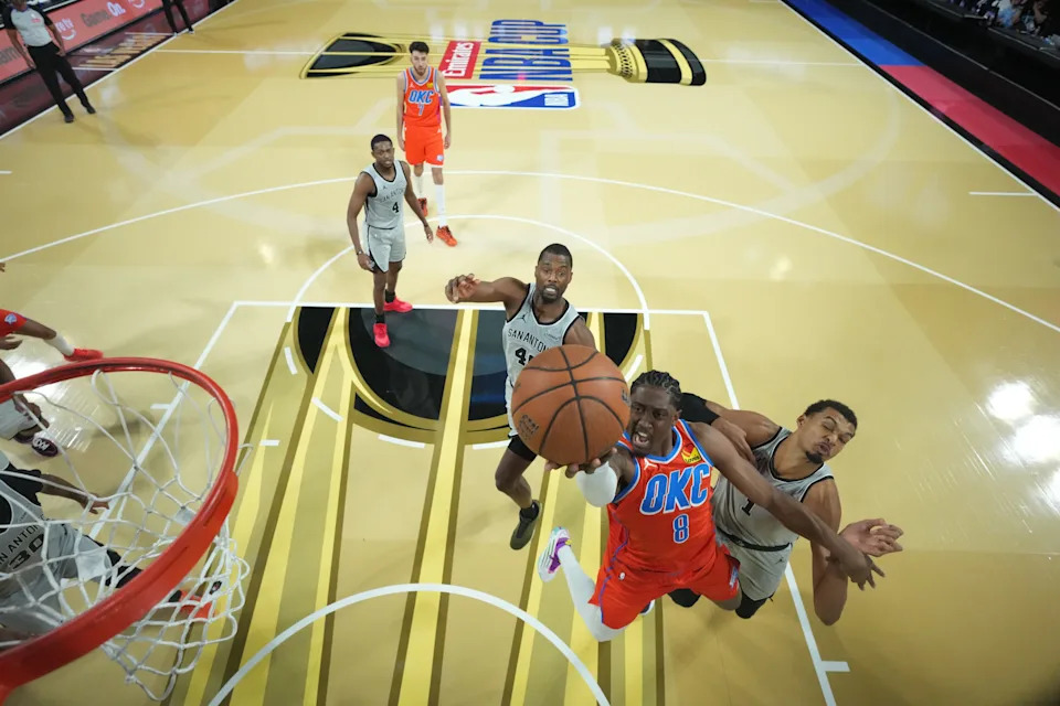 Dec 13, 2025; Las Vegas, Nevada, USA; Oklahoma City Thunder guard Jalen Williams (8) puts up a shot as San Antonio Spurs forward Victor Wembanyama (1) and forward Harrison Barnes (40) defend during the second half at T-Mobile Arena. Mandatory Credit: Kirby Lee-Imagn Images