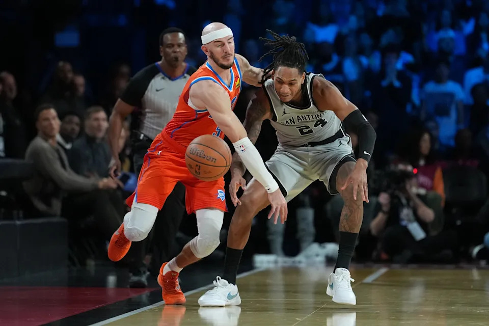 Dec 13, 2025; Las Vegas, Nevada, USA; Oklahoma City Thunder guard Alex Caruso (9) and San Antonio Spurs guard Devin Vassell (24) battle for the lose ball during the fourth quarter at T-Mobile Arena. Mandatory Credit: Kirby Lee-Imagn Images
