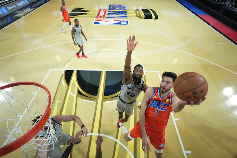 Dec 13, 2025; Las Vegas, Nevada, USA; Oklahoma City Thunder center Chet Holmgren (7) goes in for the lay up as San Antonio Spurs forward Harrison Barnes (40) defends during the second half at T-Mobile Arena. Mandatory Credit: Kirby Lee-Imagn Images
