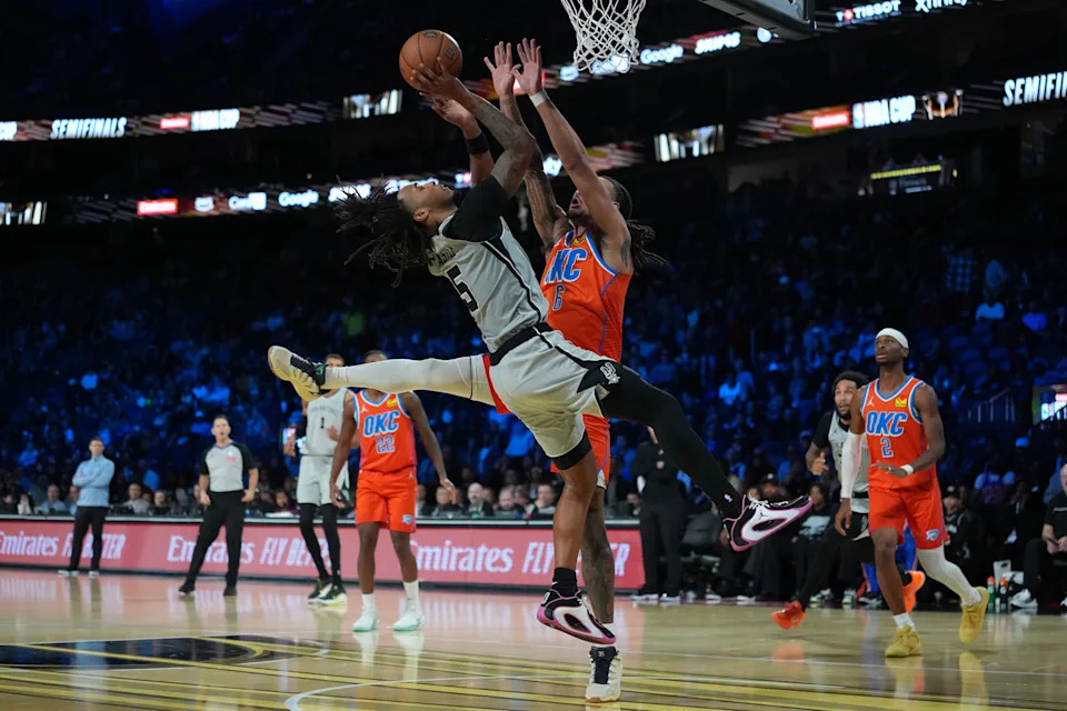 Dec 13, 2025; Las Vegas, Nevada, USA; San Antonio Spurs guard Stephon Castle (5) drives the lane on Oklahoma City Thunder forward Jaylin Williams (6) during the third quarter at T-Mobile Arena. Mandatory Credit: Kirby Lee-Imagn Images