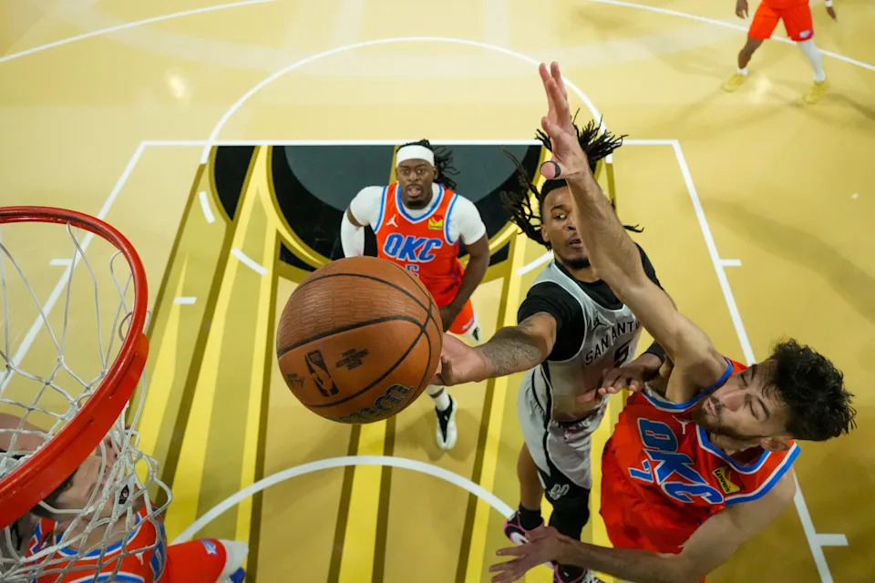 Dec 13, 2025; Las Vegas, Nevada, USA; San Antonio Spurs guard Stephon Castle (5) drives to the basket on Oklahoma City Thunder center Chet Holmgren (7) during the first quarter at T-Mobile Arena. Mandatory Credit: Kirby Lee-Imagn Images