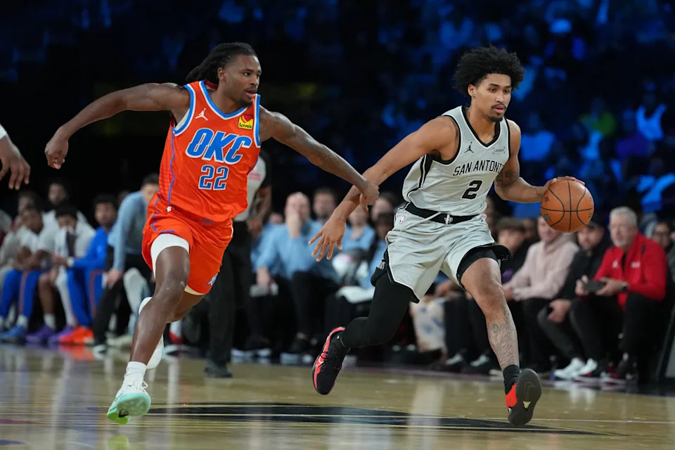Dec 13, 2025; Las Vegas, Nevada, USA; San Antonio Spurs guard Dylan Harper (2) brings the ball up court as Oklahoma City Thunder guard Cason Wallace (22) defends during the third quarter at T-Mobile Arena. Mandatory Credit: Kirby Lee-Imagn Images