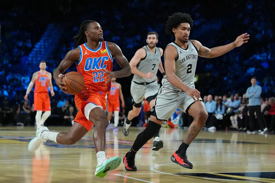 Dec 13, 2025; Las Vegas, Nevada, USA; Oklahoma City Thunder guard Cason Wallace (22) drives the lane as San Antonio Spurs guard Dylan Harper (2) defends during the second quarter at T-Mobile Arena. Mandatory Credit: Kirby Lee-Imagn Images
