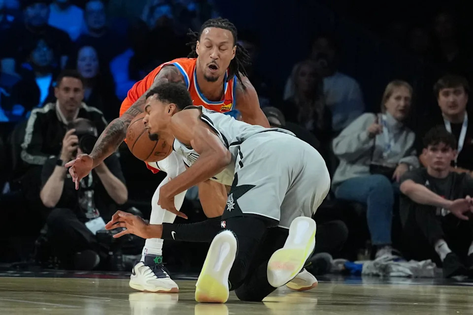 Dec 13, 2025; Las Vegas, Nevada, USA; Oklahoma City Thunder forward Jaylin Williams (6) and San Antonio Spurs forward Victor Wembanyama (1) battle for the loose ball during the second quarter at T-Mobile Arena. Mandatory Credit: Kirby Lee-Imagn Images