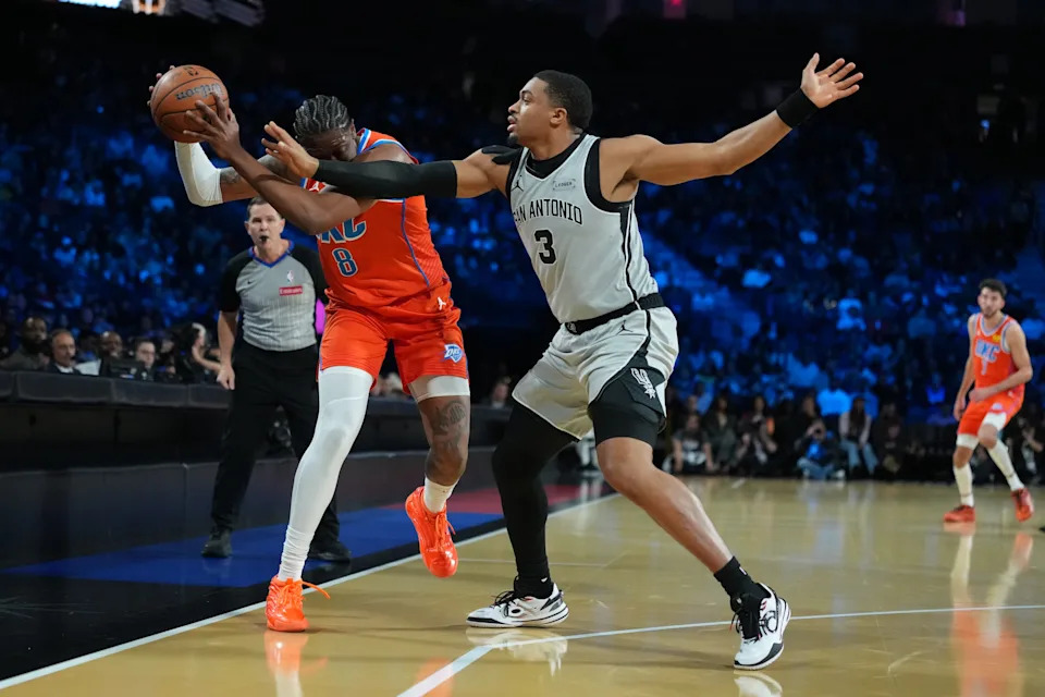 Dec 13, 2025; Las Vegas, Nevada, USA; Oklahoma City Thunder guard Jalen Williams (8) grabs the loose bal in front of San Antonio Spurs forward Keldon Johnson (3) during the first quarter at T-Mobile Arena. Mandatory Credit: Kirby Lee-Imagn Images