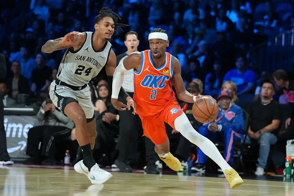 Dec 13, 2025; Las Vegas, Nevada, USA; Oklahoma City Thunder guard Shai Gilgeous-Alexander (2) works around San Antonio Spurs guard Devin Vassell (24) during the first quarter at T-Mobile Arena. Mandatory Credit: Kirby Lee-Imagn Images
