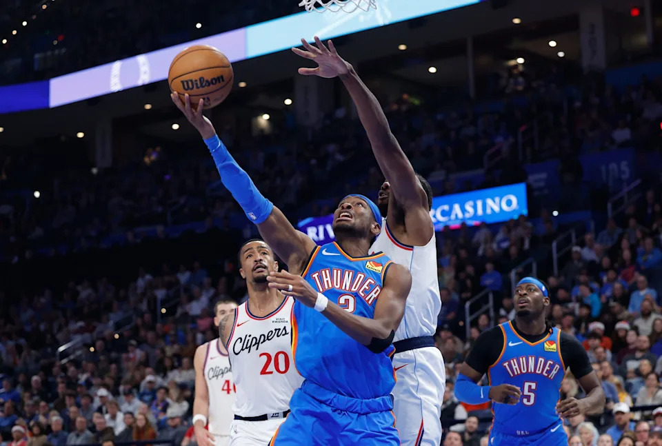 Dec 18, 2025; Oklahoma City, Oklahoma, USA; Oklahoma City Thunder guard Shai Gilgeous-Alexander (2) shoots a scores in front of Los Angeles Clippers forward Kawhi Leonard (2) during the second quarter at Paycom Center. Mandatory Credit: Alonzo Adams-Imagn Images