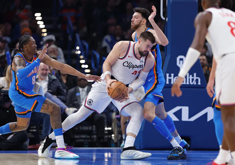 Dec 18, 2025; Oklahoma City, Oklahoma, USA; Los Angeles Clippers center Ivica Zubac (40) drives against Oklahoma City Thunder center Chet Holmgren (7) during the second quarter at Paycom Center. Mandatory Credit: Alonzo Adams-Imagn Images