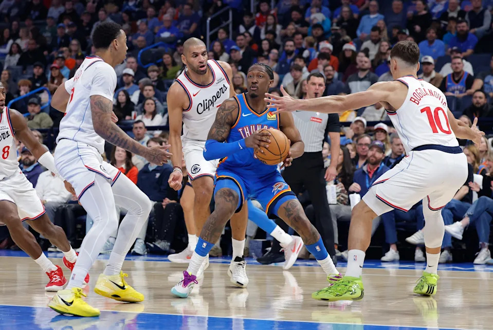 Dec 18, 2025; Oklahoma City, Oklahoma, USA;Oklahoma City Thunder guard Jalen Williams (8) moves the ball between Los Angeles Clippers guard Jordan Miller (22), and guard Bogdan Bogdanovic (10) during the second quarter at Paycom Center. Mandatory Credit: Alonzo Adams-Imagn Images