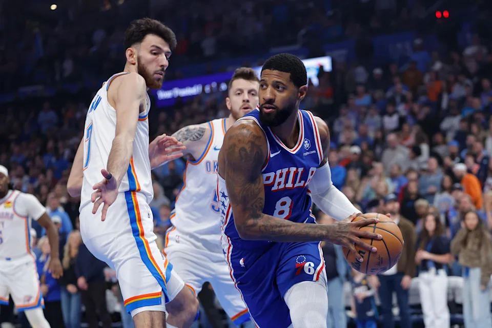 Dec 28, 2025; Oklahoma City, Oklahoma, USA; Philadelphia 76ers forward Paul George (8) moves the ball around Oklahoma City Thunder center Chet Holmgren (7) during the first quarter at Paycom Center. Mandatory Credit: Alonzo Adams-Imagn Images