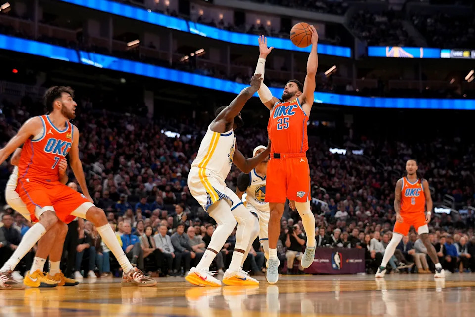 Dec 2, 2025; San Francisco, California, USA; Oklahoma City Thunder guard Ajay Mitchell (25) makes a shot over Golden State Warriors forward Draymond Green (23) in the fourth quarter at the Chase Center. Mandatory Credit: Cary Edmondson-Imagn Images