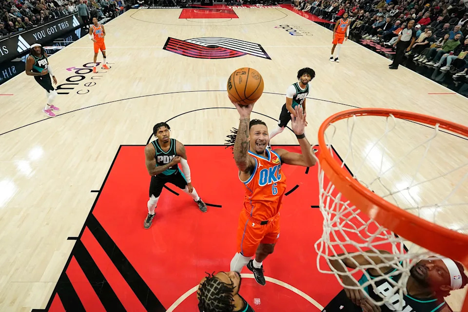 PORTLAND, OREGON - NOVEMBER 30: Jaylin Williams #6 of the Oklahoma City Thunder shoots over Jerami Grant #9 and Rayan Rupert #21 of the Portland Trail Blazers during the first half at Moda Center on November 30, 2025 in Portland, Oregon. NOTE TO USER: User expressly acknowledges and agrees that, by downloading and or using this photograph, User is consenting to the terms and conditions of the Getty Images License Agreement. (Photo by Soobum Im/Getty Images)