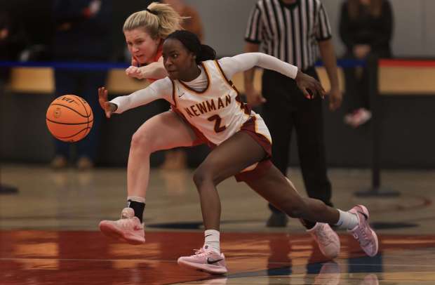 Cardinal Newman's Valor Queen steals the basketball past Lucy Parchman of Montgomery during last season's NBL-Oak League championship game in Rohnert Park. (Kent Porter - The Press Democrat)