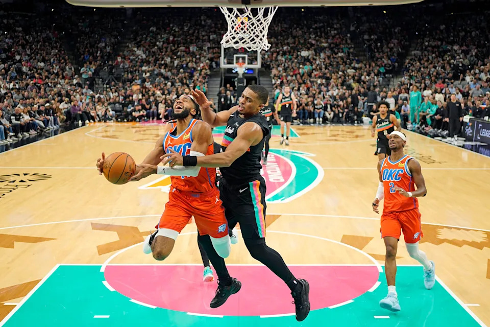 Dec 23, 2025; San Antonio, Texas, USA; Oklahoma City Thunder guard Isaiah Joe (11) drives to the basket against San Antonio Spurs forward Keldon Johnson (3) during the first half at Frost Bank Center. Mandatory Credit: Scott Wachter-Imagn Images