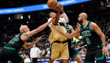 Washington Wizards guard Bub Carrington is fouled while driving to the basket by Boston Celtics guard Jordan Walsh.