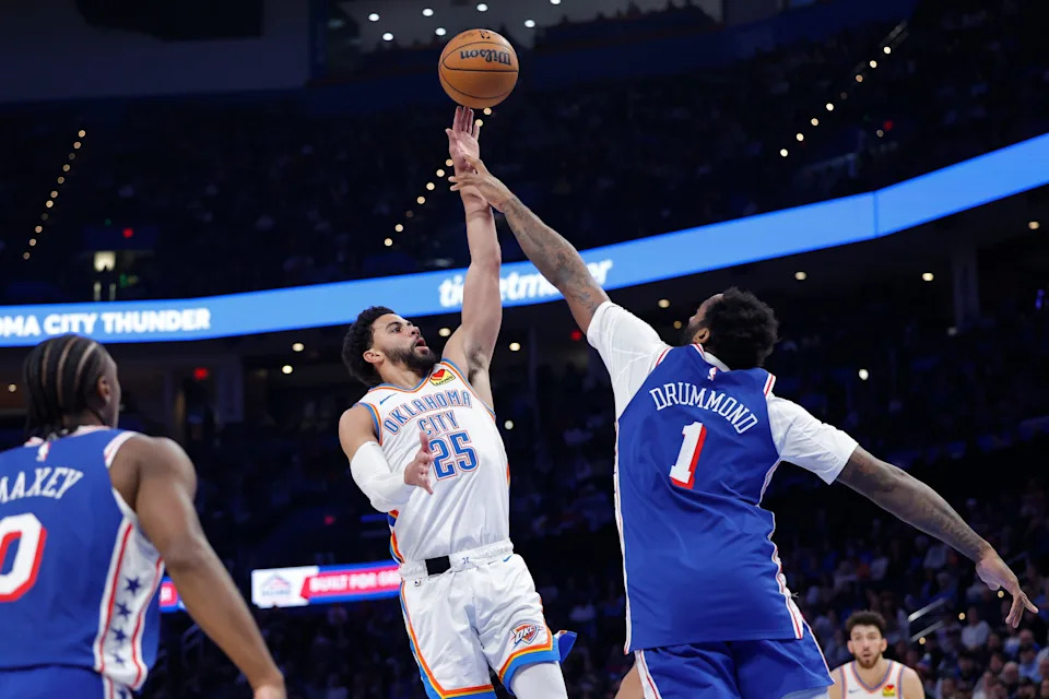 Dec 28, 2025; Oklahoma City, Oklahoma, USA; Oklahoma City Thunder guard Ajay Mitchell (25) shoots over Philadelphia 76ers center Andre Drummond (1) during the second half at Paycom Center. Mandatory Credit: Alonzo Adams-Imagn Images