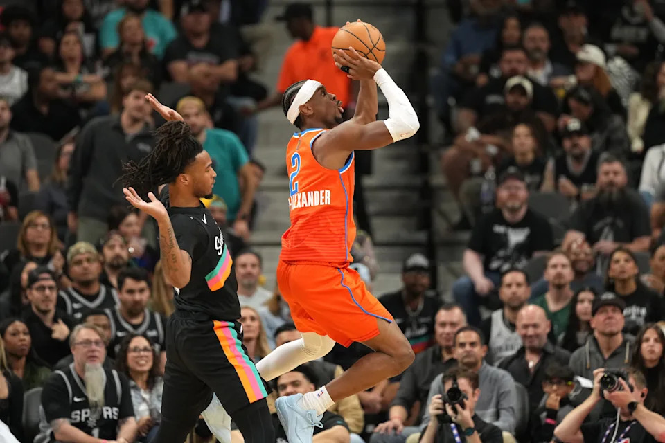 Dec 23, 2025; San Antonio, Texas, USA; Oklahoma City Thunder guard Shai Gilgeous-Alexander (2) shoots ahead of San Antonio Spurs guard Stephon Castle (5) during the first half at Frost Bank Center. Mandatory Credit: Scott Wachter-Imagn Images