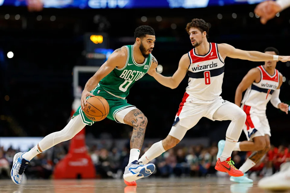 Oct 30, 2023; Washington, District of Columbia, USA; Boston Celtics forward Jayson Tatum (0) drives to the basket as Washington Wizards forward Deni Avdija (8) defends in the second quarter at Capital One Arena. Mandatory Credit: Geoff Burke-USA TODAY Sports