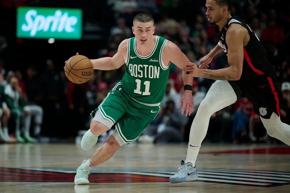 Mar 23, 2025; Portland, Oregon, USA; Boston Celtics guard Payton Pritchard (11) dribbles the ball during the second half against Portland Trail Blazers forward Toumani Camara (33) at Moda Center. Mandatory Credit: Troy Wayrynen-Imagn Images