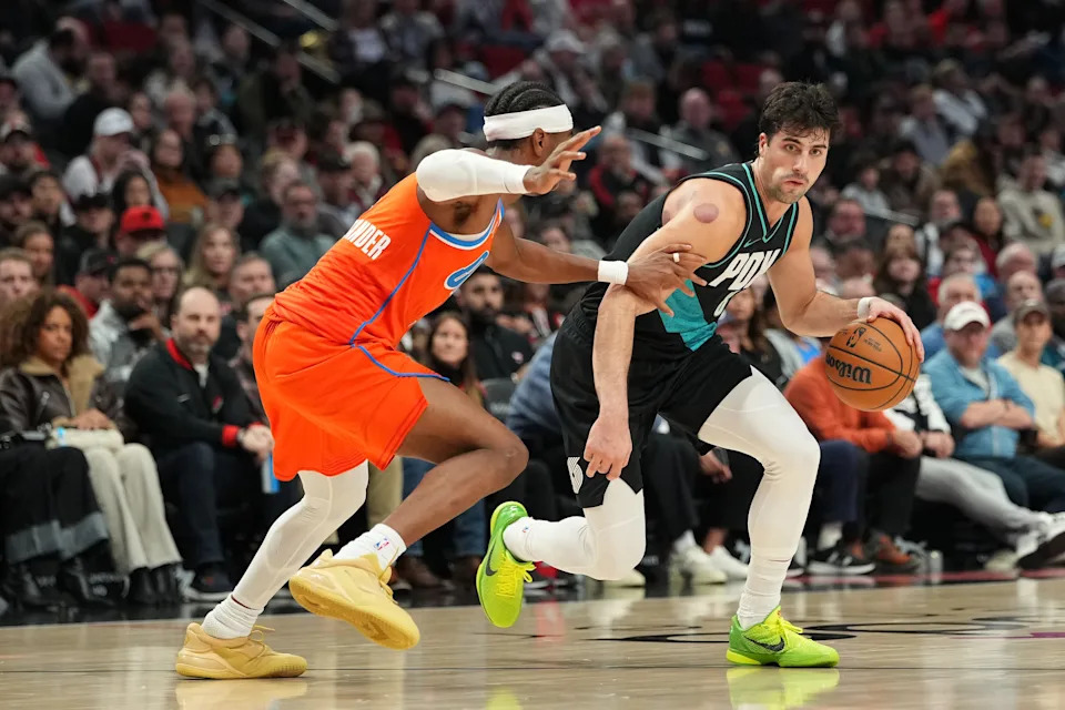 PORTLAND, OREGON - NOVEMBER 30: Deni Avdija #8 of the Portland Trail Blazers dribbles against Shai Gilgeous-Alexander #2 of the Oklahoma City Thunder during the first half at Moda Center on November 30, 2025 in Portland, Oregon. NOTE TO USER: User expressly acknowledges and agrees that, by downloading and or using this photograph, User is consenting to the terms and conditions of the Getty Images License Agreement. (Photo by Soobum Im/Getty Images)
