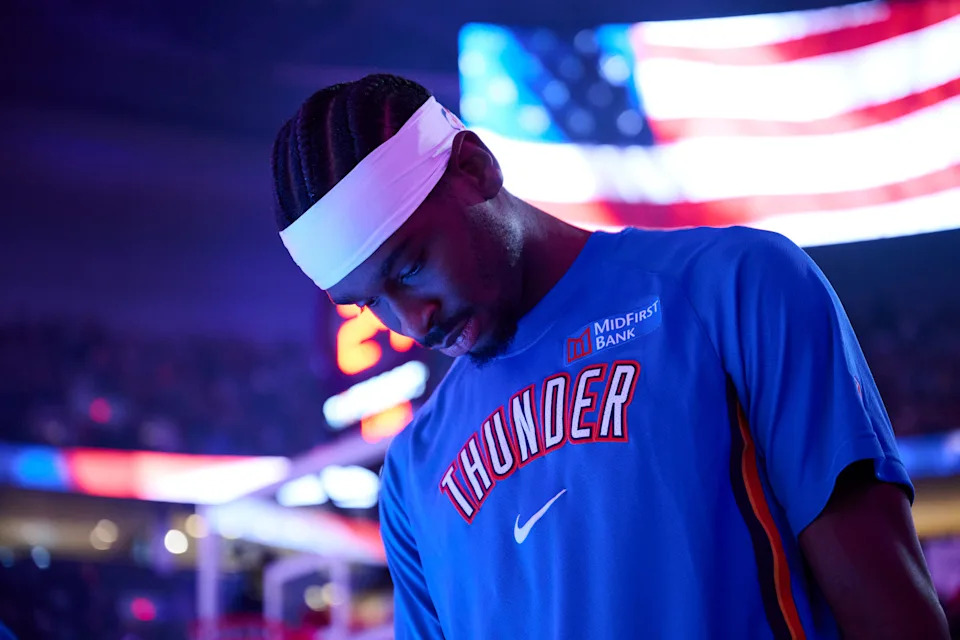 Nov 30, 2025; Portland, Oregon, USA; Oklahoma City Thunder guard Shai Gilgeous-Alexander (2) stands during the singing of the national anthem before a game against the Portland Trail Blazers at Moda Center. Mandatory Credit: Troy Wayrynen-Imagn Images