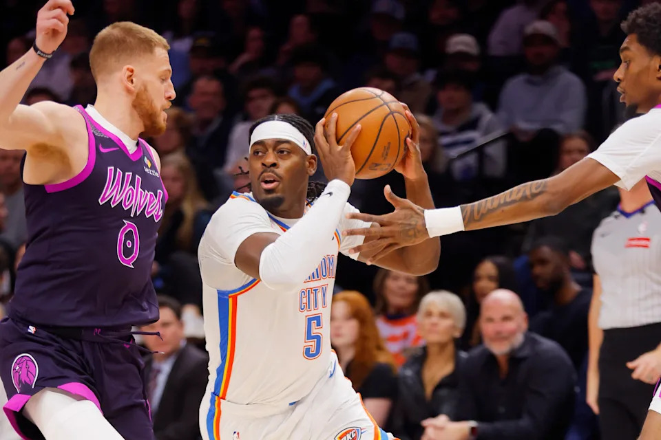 Dec 19, 2025; Minneapolis, Minnesota, USA; Oklahoma City Thunder forward Luguentz Dort (5) works between Minnesota Timberwolves guard Donte DiVincenzo (0) and forward Jaden McDaniels (3) in the first quarter at Target Center. Mandatory Credit: Bruce Kluckhohn-Imagn Images