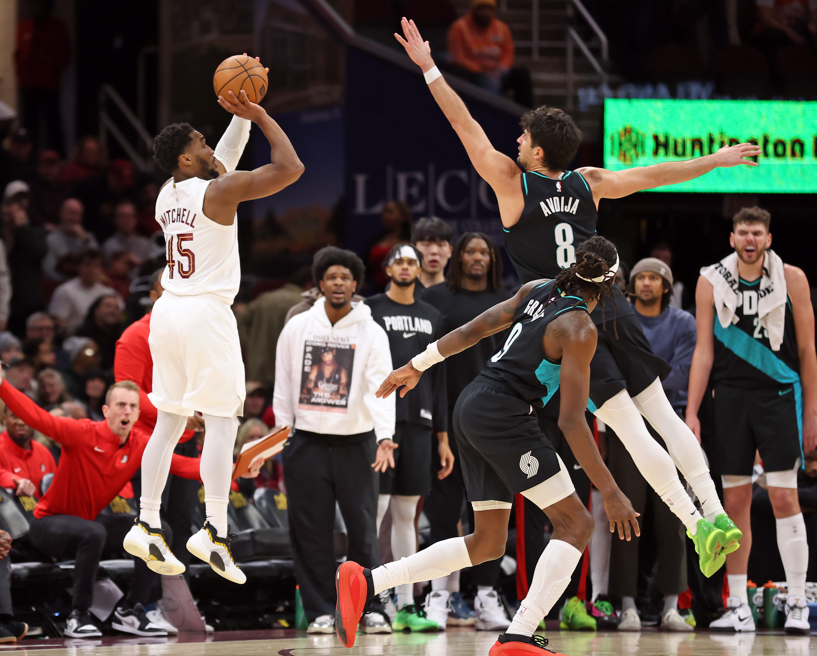 Cleveland Cavaliers guard Donovan Mitchell shoots over Portland Trail Blazers forward Deni Avdija in the second half of play. 