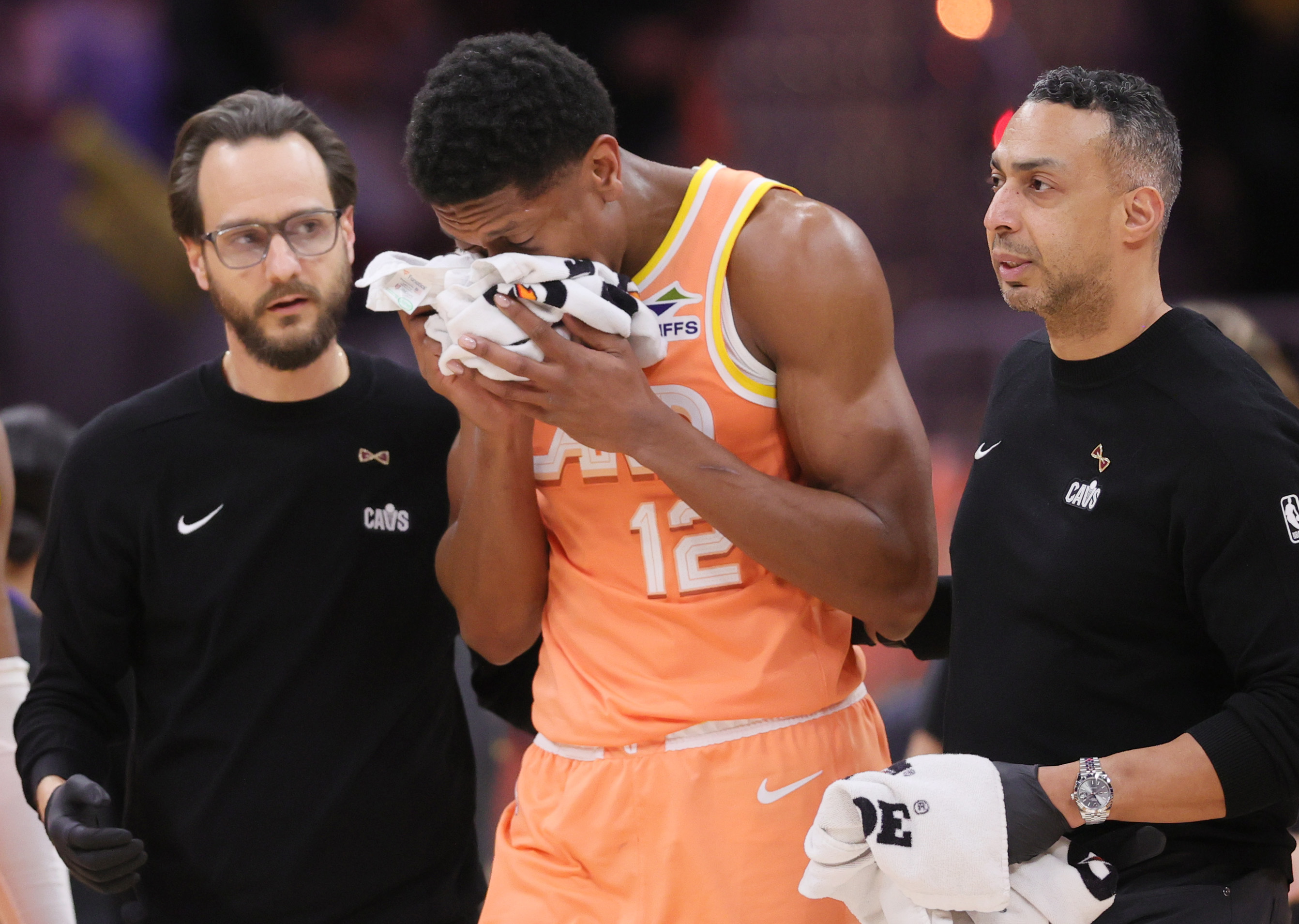 Cleveland Cavaliers forward De'Andre Hunter holds a towel to his nose after being hit in the face with the assistance of Cavs’ medical staff in the second half at Rocket Arena.