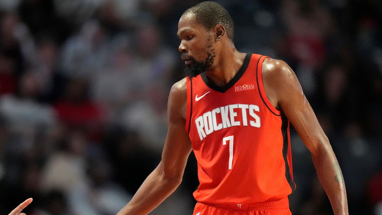 Houston Rockets forward Kevin Durant (7) greets fans during the second half of an NBA preseason basketball game against the New Orleans Pelicans, Tuesday, Oct. 14, 2025, in Birmingham, Ala. (AP Photo/Mike Stewart)