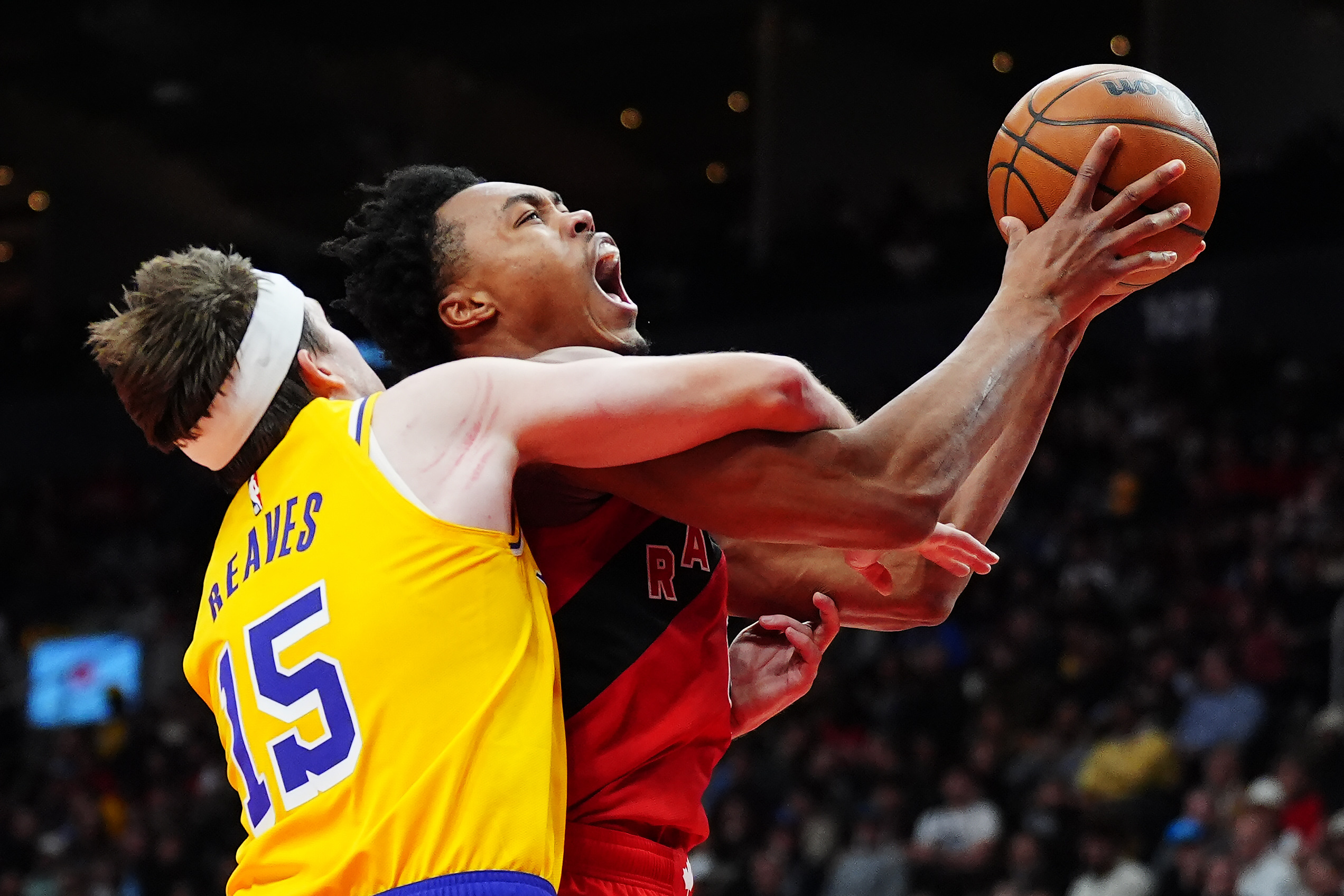 Lakers guard Austin Reaves, left, fouls the Toronto Raptors’ Scottie...