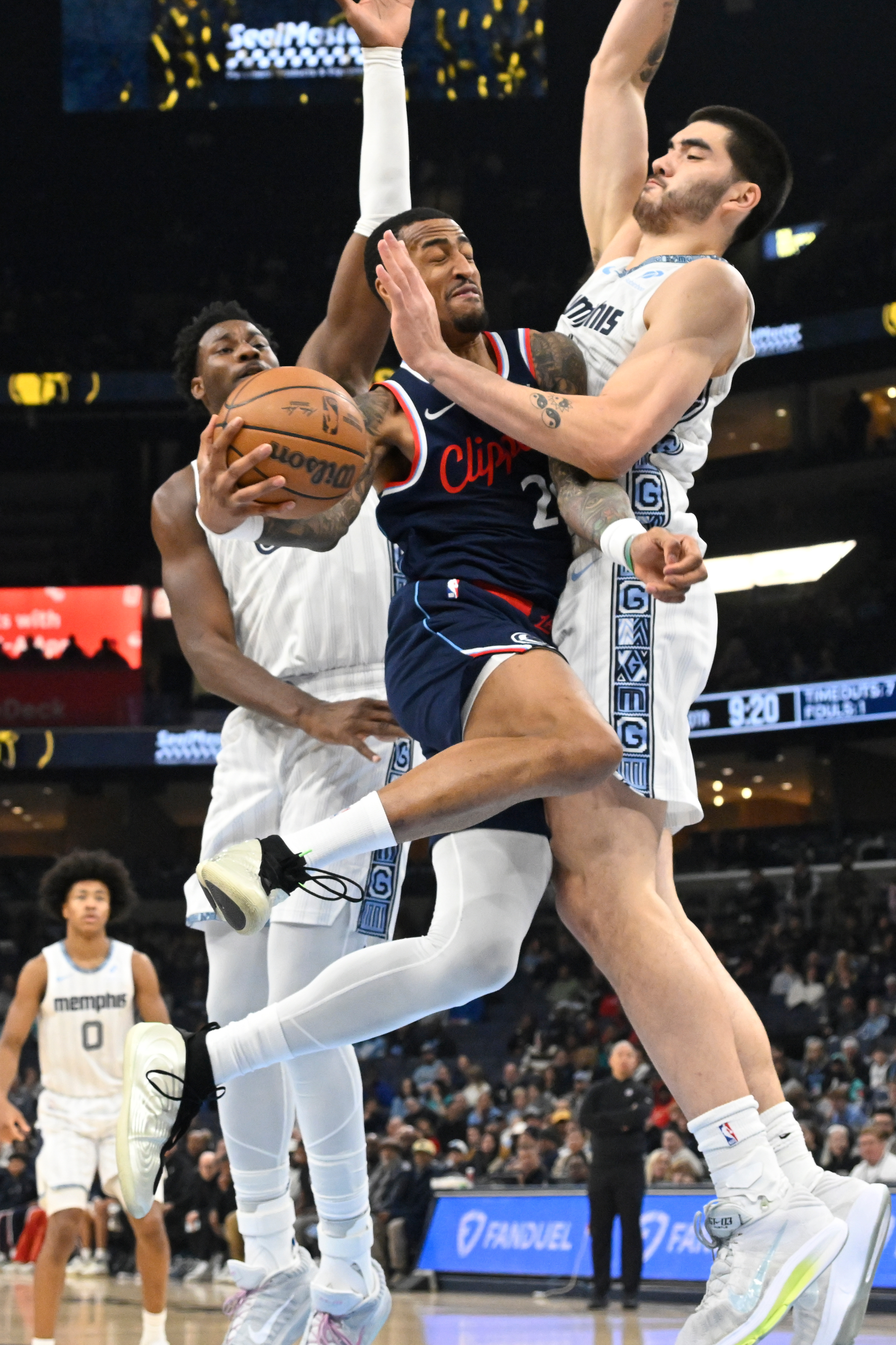 Clippers forward John Collins drives as Memphis Grizzlies center Zach...