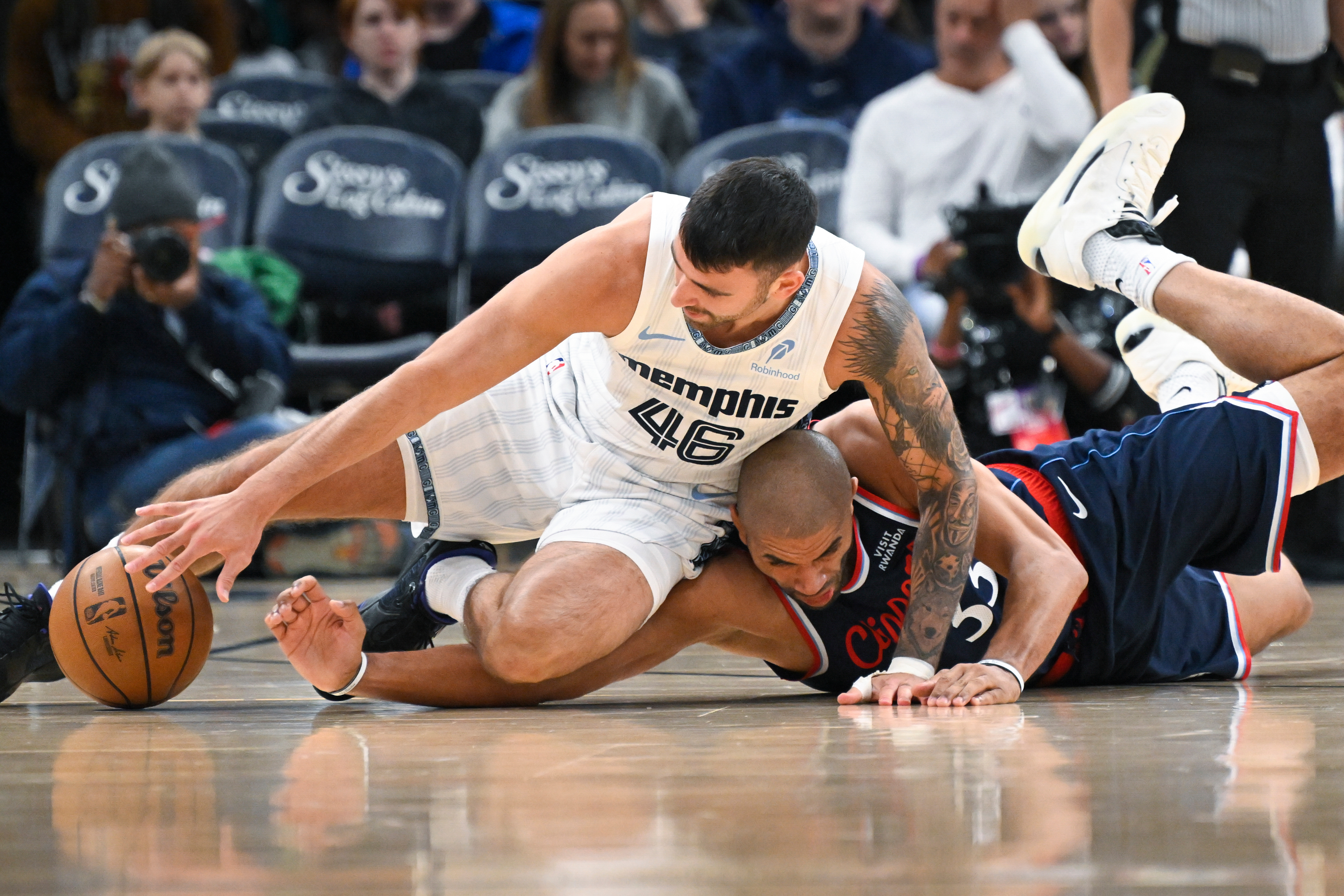 Memphis Grizzlies guard John Konchar, left, and Clippers forward Nicolas...
