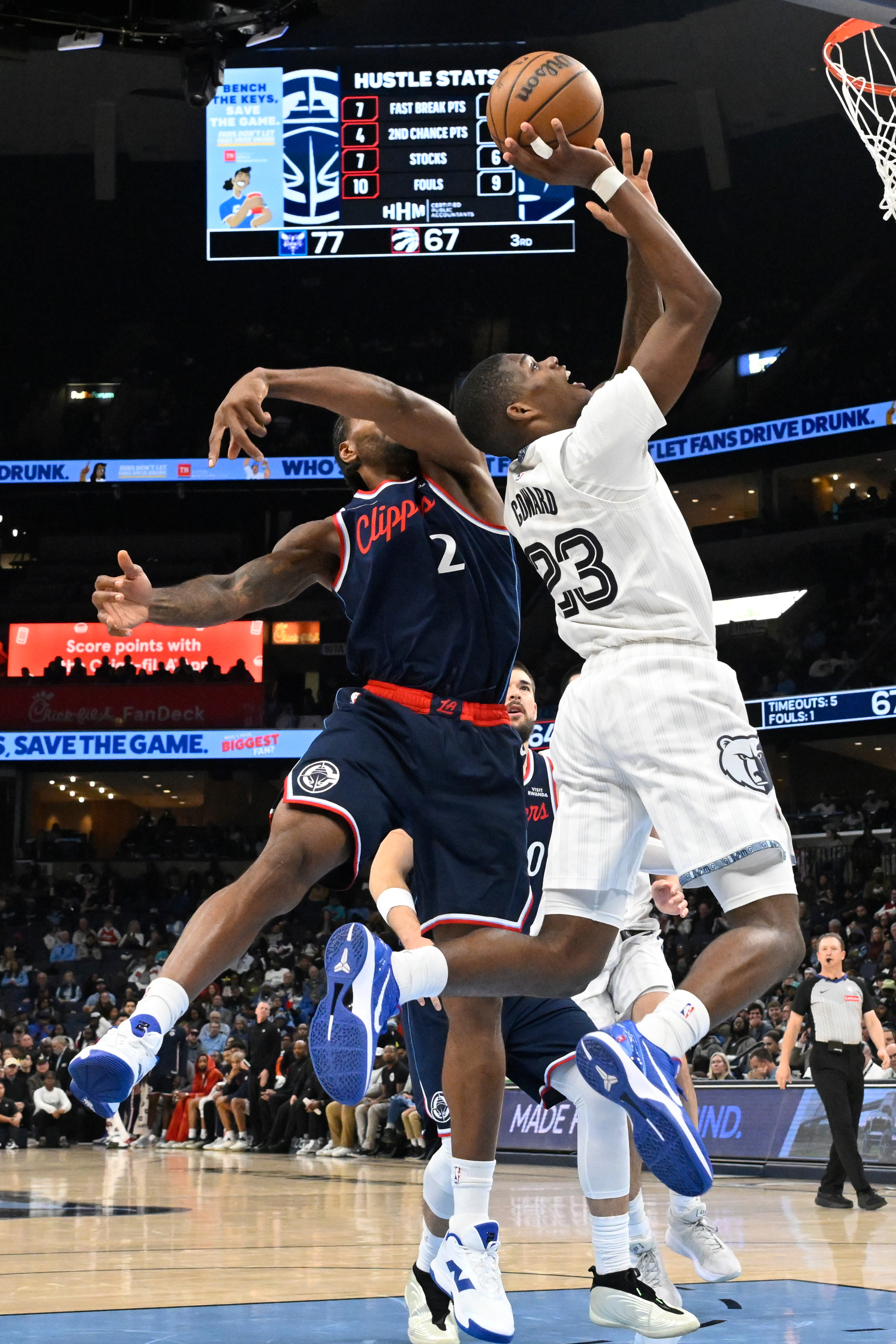 Memphis Grizzlies guard Cedric Coward (23) goes up to shoot...