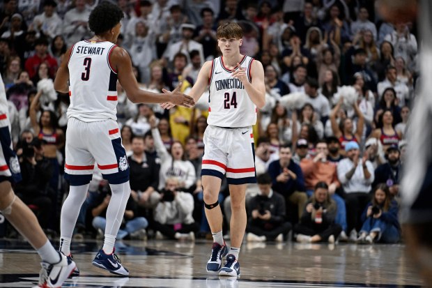 UConn guard Braylon Mullins (24) and UConn forward Jaylin Stewart (3) in the second half of an NCAA college basketball game against East Texas A&M, Friday, Dec. 5, 2025, in Storrs, Conn. (AP Photo/Jessica Hill)