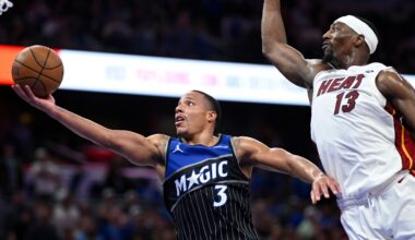 Orlando Magic guard Desmond Bane (3) goes up to shoot as Miami Heat center Bam Adebayo (13) defends during the second half of an NBA Cup basketball game, Tuesday, Dec. 9, 2025, in Orlando, Fla. (AP Photo/Phelan M. Ebenhack)