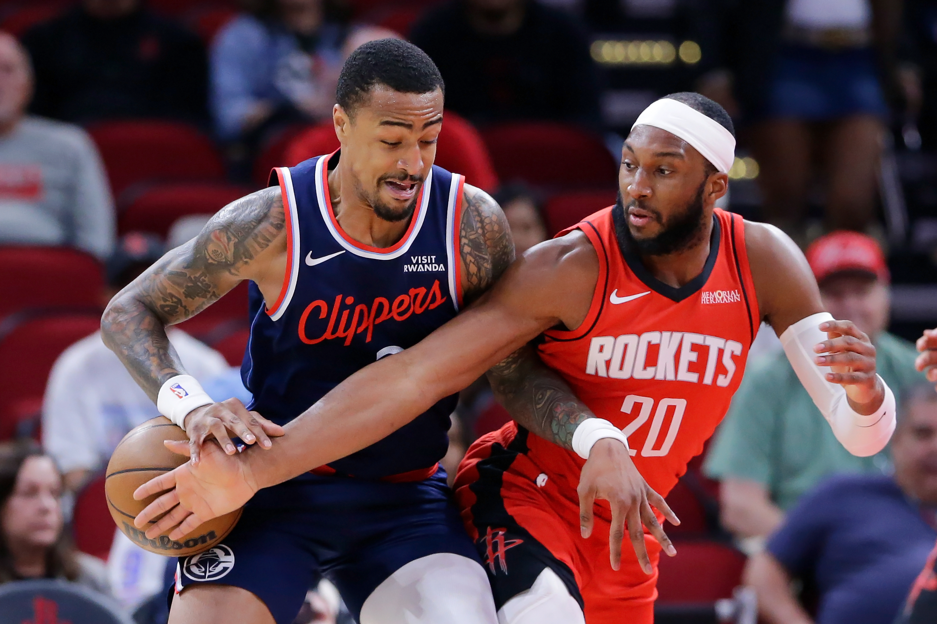 Houston Rockets guard Josh Okogie, right, knocks the ball away...
