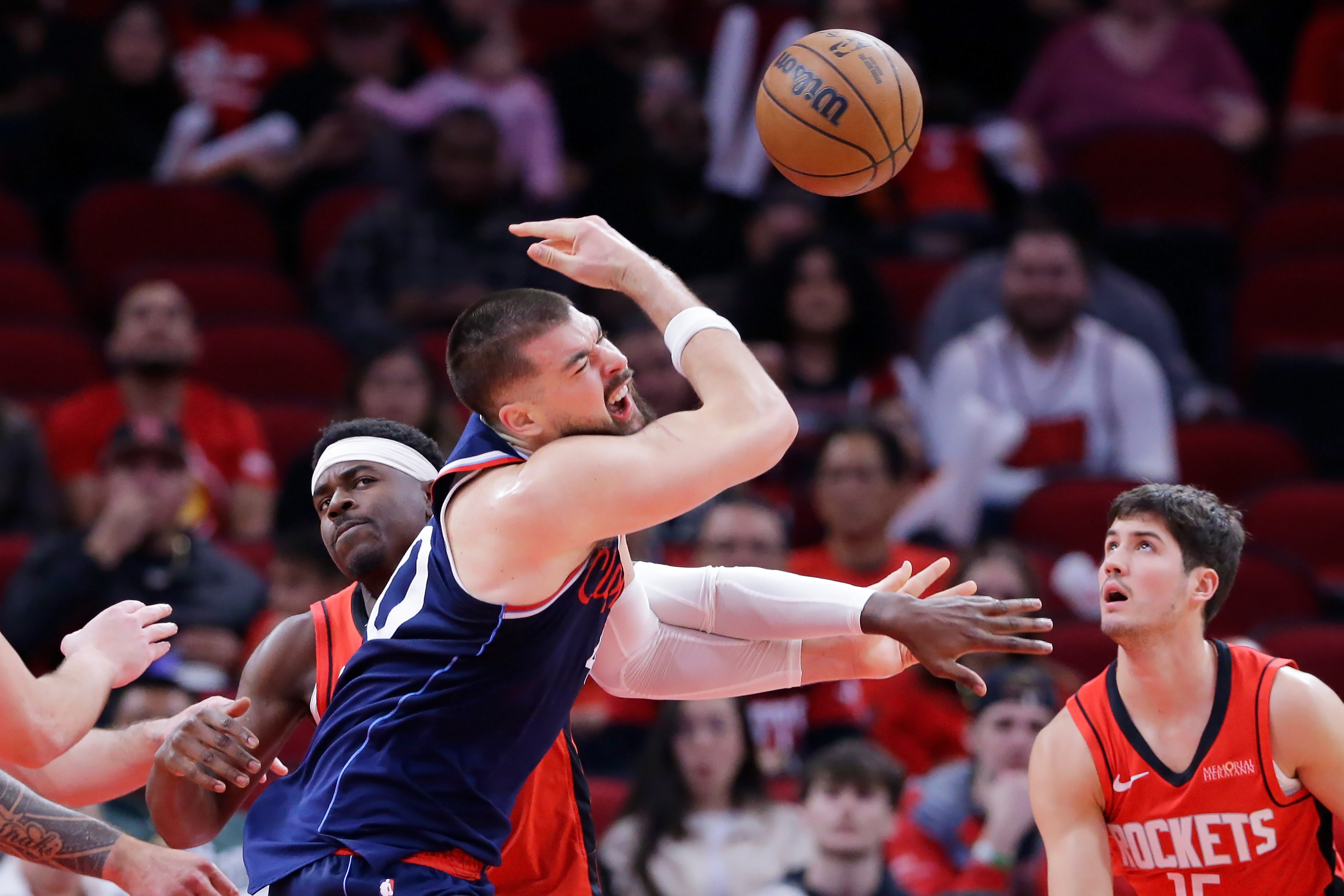 Houston Rockets guard Aaron Holiday, left, knocks the ball away...