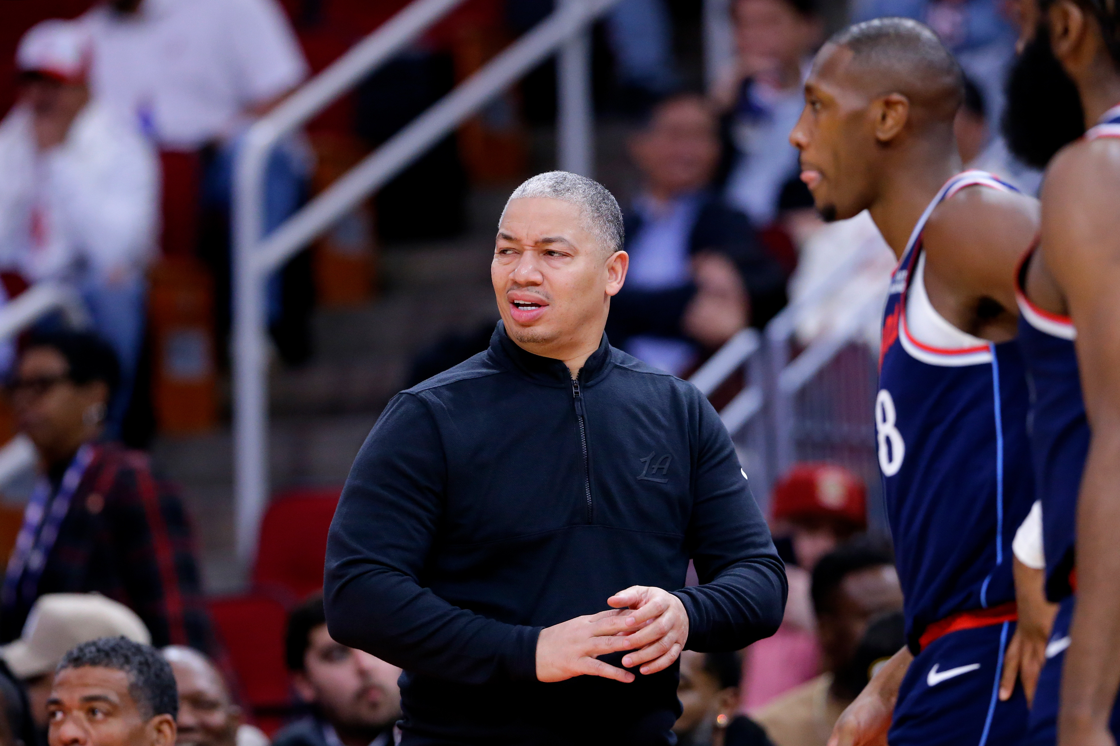 Clippers head coach Tyronn Lue reacts next to guard Kris...