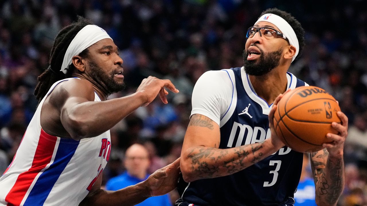 Dallas Mavericks forward Anthony Davis (3) works for a shot attempt against Detroit Pistons forward Isaiah Stewart, left, in the first half of an NBA basketball game in Dallas, Thursday, Dec. 18, 2025. (AP Photo/Tony Gutierrez)
