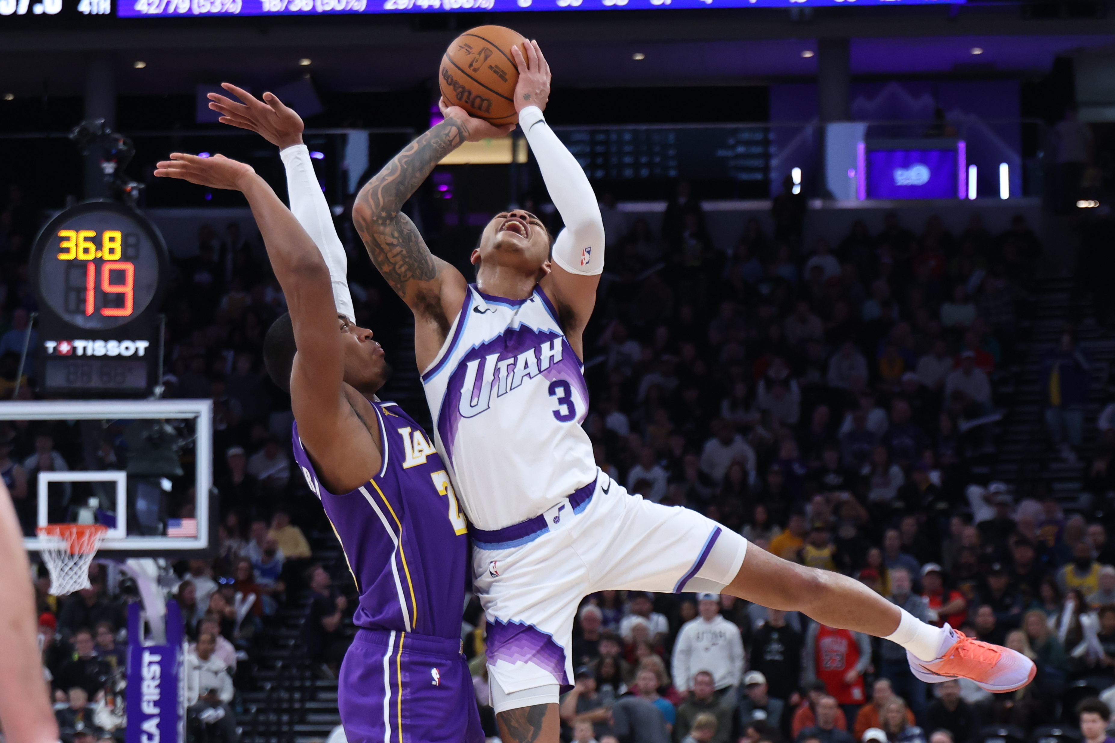Utah Jazz guard Keyonte George (3) is fouled by Lakers...