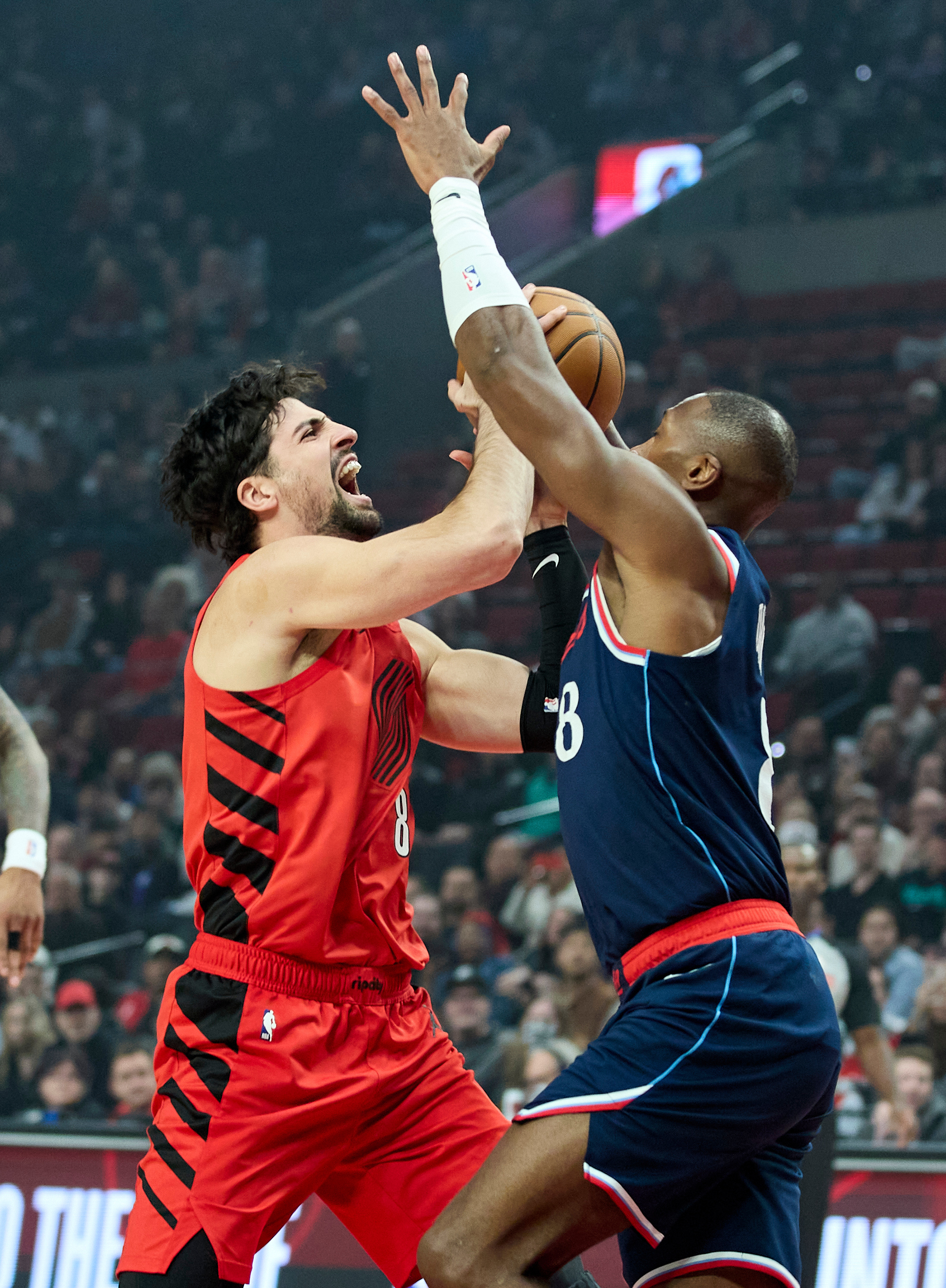 Portland Trail Blazers forward Deni Avdija, left, looks to shoot...