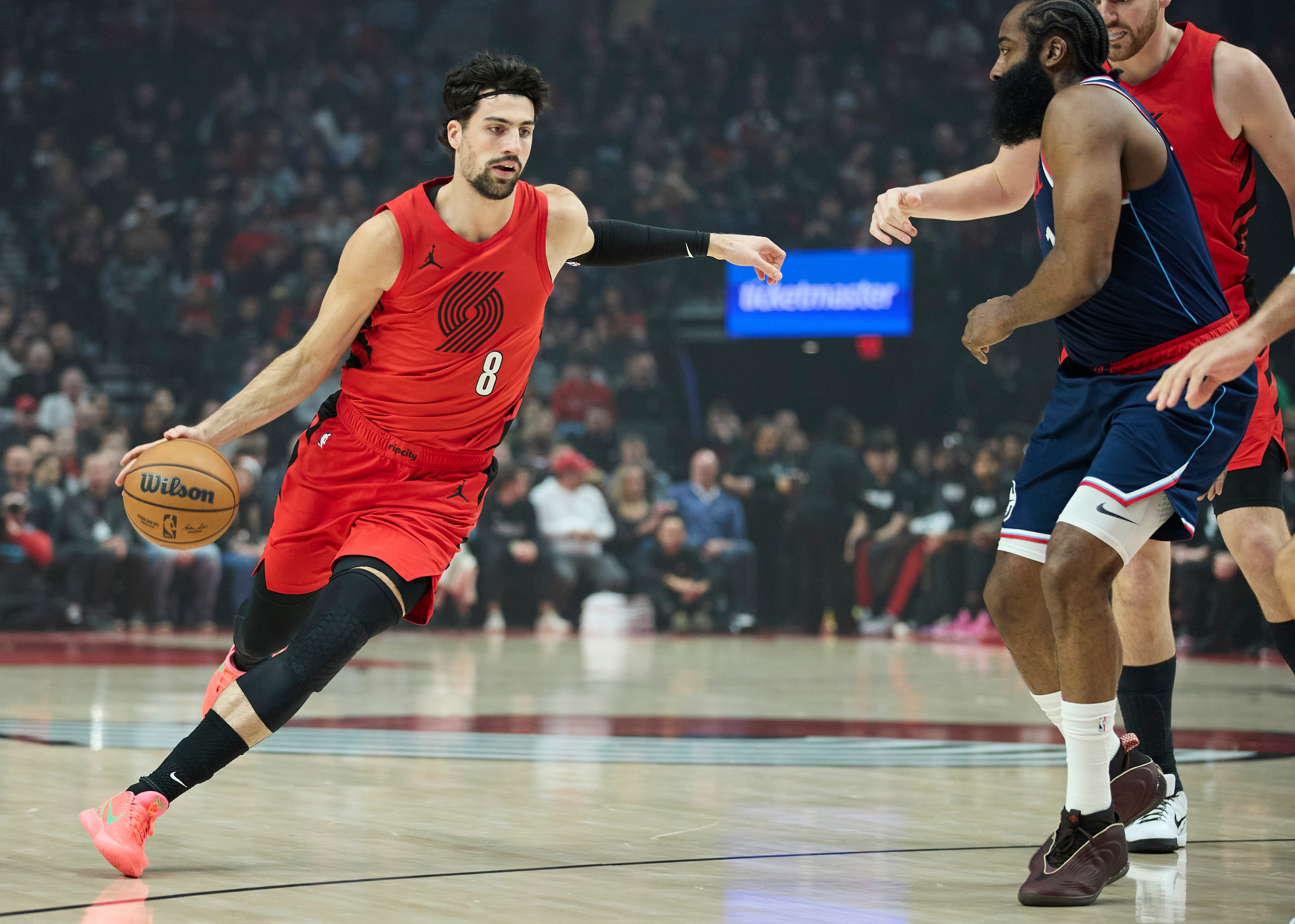 Portland Trail Blazers forward Deni Avdija, left, dribbles around Clippers...