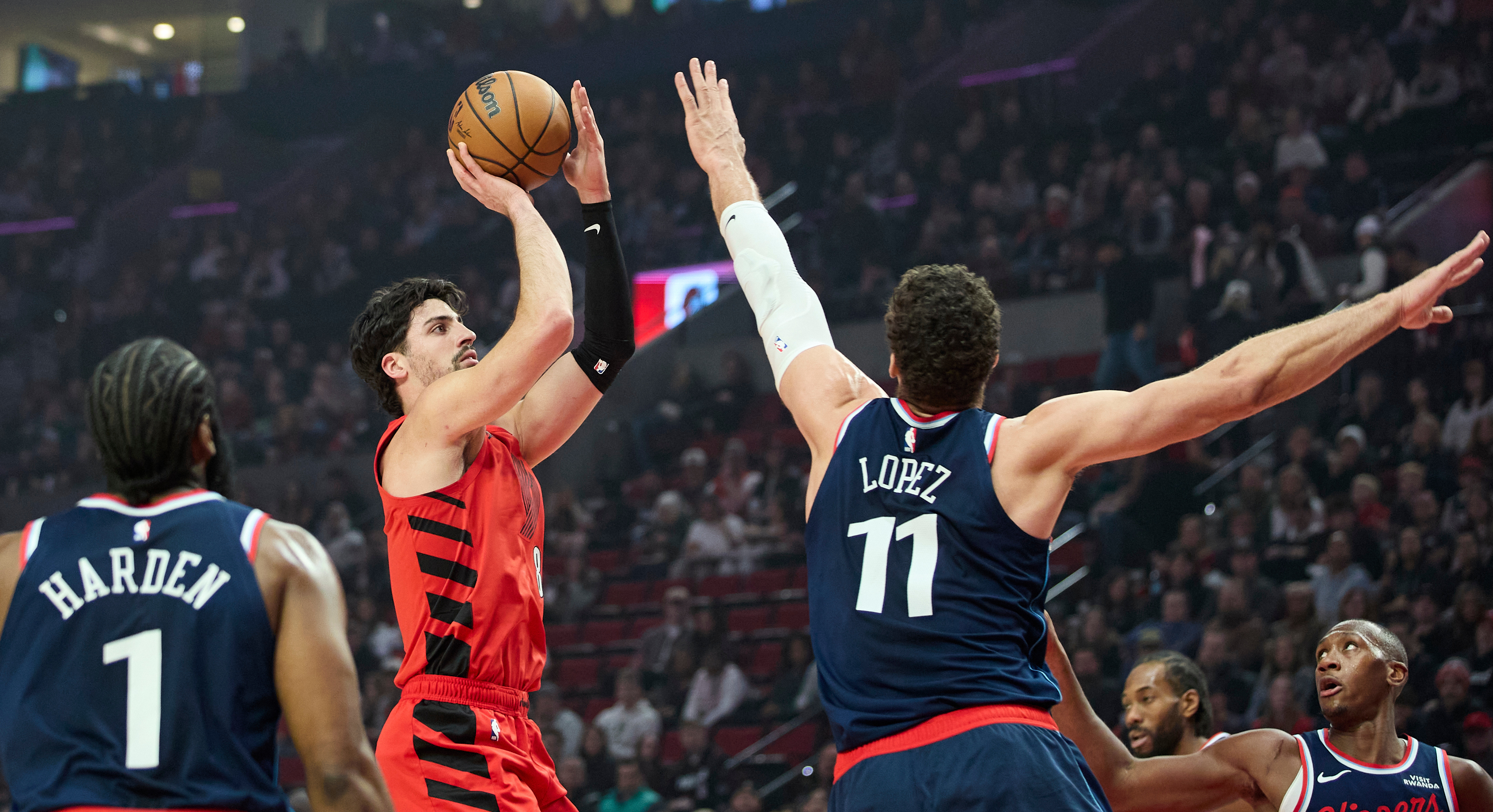 Portland Trail Blazers forward Deni Avdija, center, shoots between Clippers...