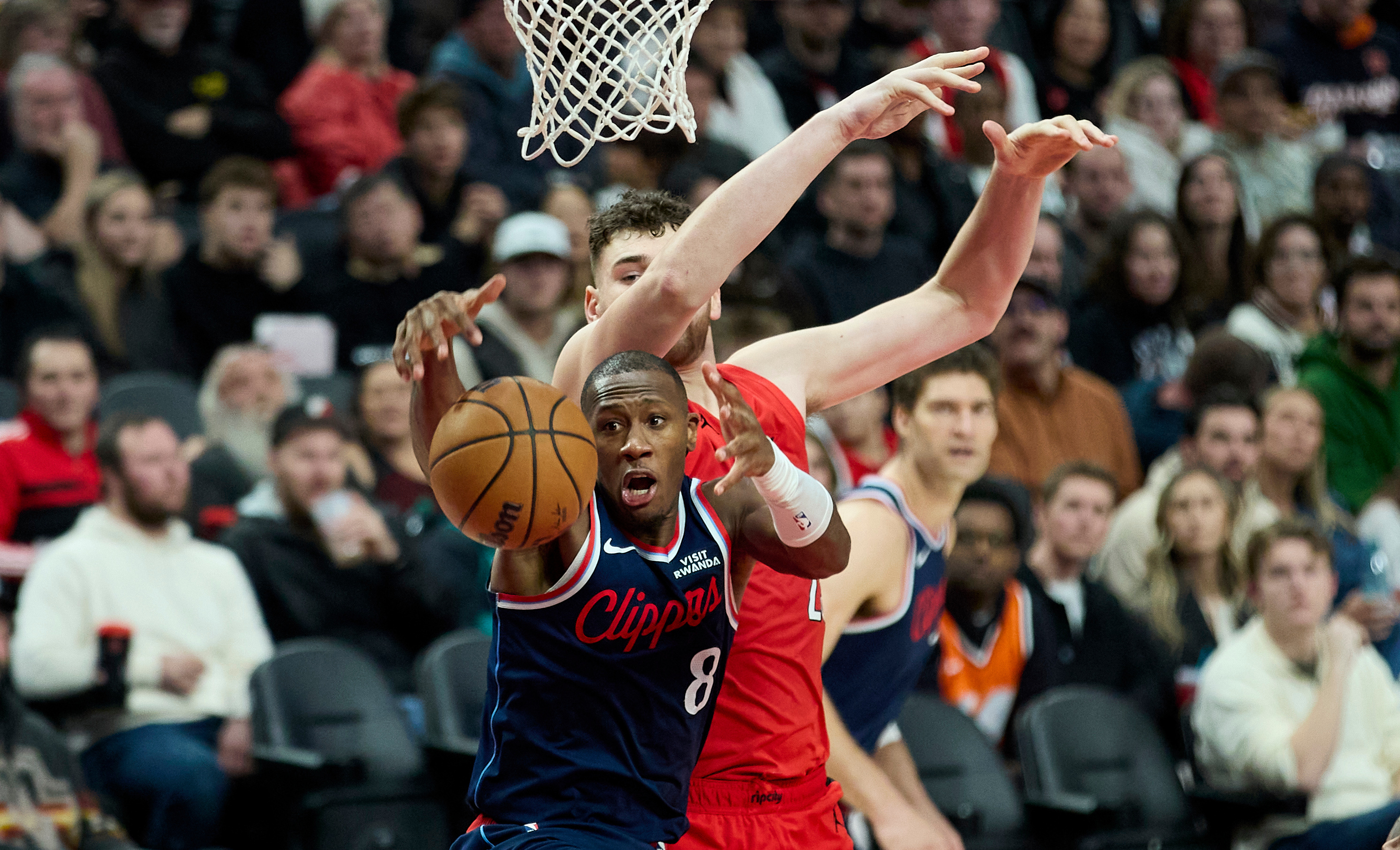 Clippers guard Kris Dunn (8) collects a rebound in front...