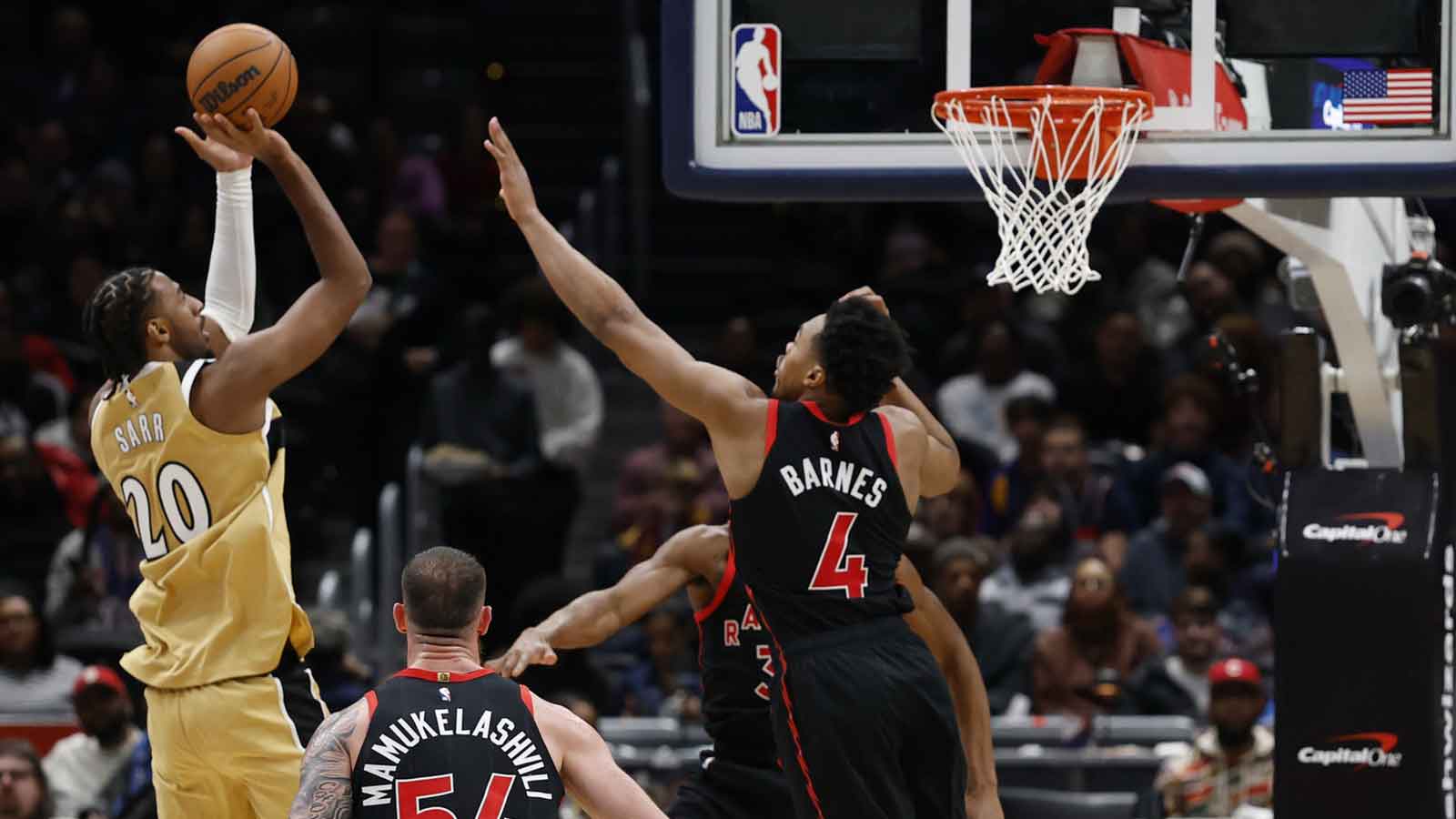 Washington Wizards center Alex Sarr (20) shoots the ball as Toronto Raptors forward Scottie Barnes (4) defends in the first half at Capital One Arena.