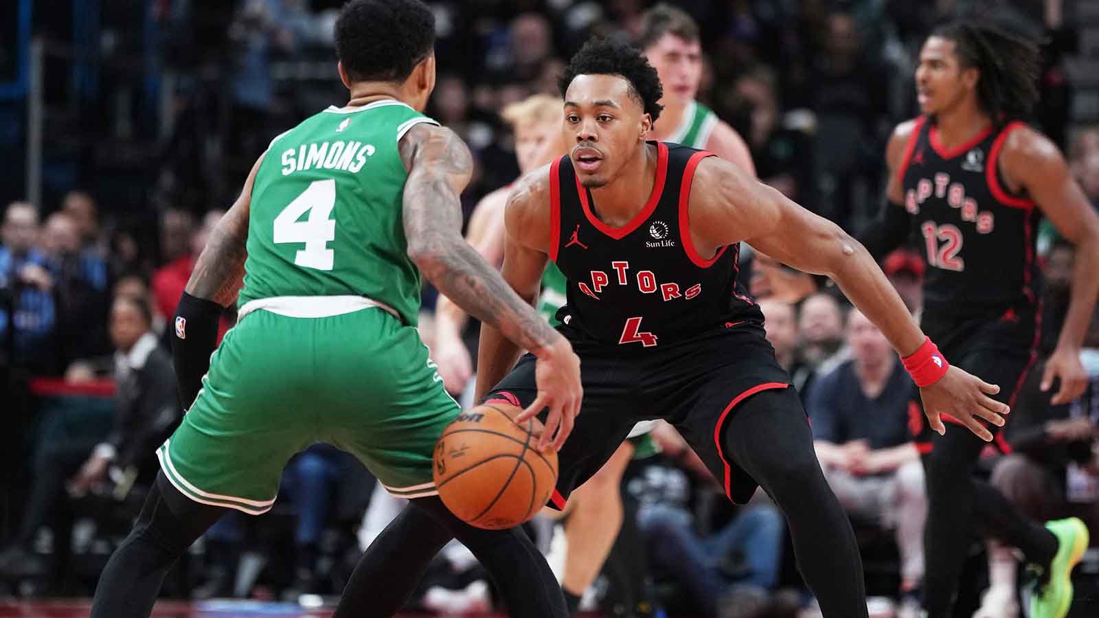Boston Celtics guard Anfernee Simons (4) controls the ball as Toronto Raptors forward Scottie Barnes (4) tries to defend during the third quarter at Scotiabank Arena. 