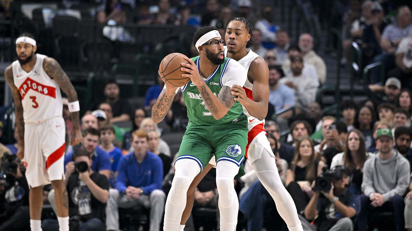 Dallas Mavericks forward Anthony Davis (3) looks to move the ball past Toronto Raptors forward Scottie Barnes (4) during the game between the Mavericks and the Raptors at the American Airlines Center