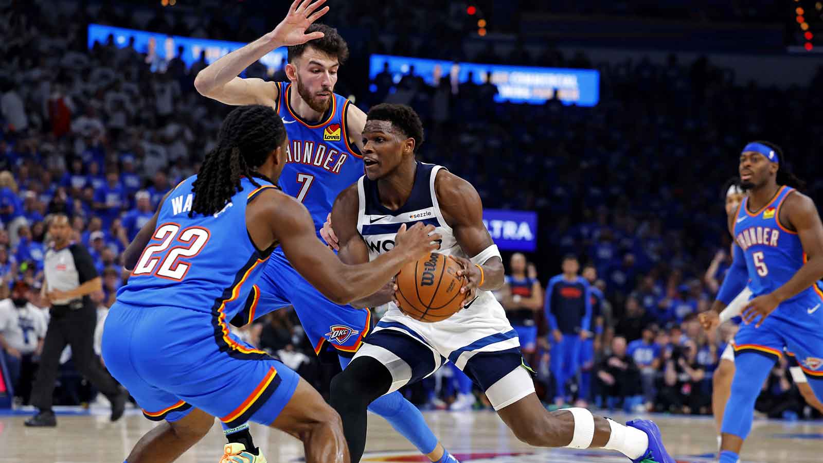 Minnesota Timberwolves guard Anthony Edwards (5) drives to the basket against Oklahoma City Thunder guard Cason Wallace (22) during the second quarter in game five of the western conference finals for the 2025 NBA Playoffs at Paycom Center. 